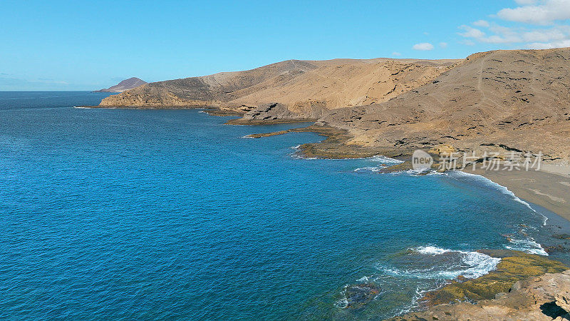 Aerial view of the beach "Playa Escondida" and the natural reserve of "Montaña Pelada" in Tenerife (Canary Islands). Drone shot